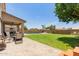 Spacious backyard with lush lawn, pool, and covered patio, perfect for outdoor entertaining at 14099 W Riviera Dr, Surprise, AZ 85379