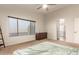 Spacious bedroom with a ceiling fan, neutral walls, carpet, and a window for natural light at 14099 W Riviera Dr, Surprise, AZ 85379