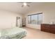 Cozy bedroom with a ceiling fan and large window for plenty of natural light at 14099 W Riviera Dr, Surprise, AZ 85379