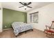 This cozy bedroom boasts a ceiling fan and an accent wall in addition to natural light at 14099 W Riviera Dr, Surprise, AZ 85379