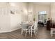 Open dining room with vaulted ceilings and modern wood floors at 14099 W Riviera Dr, Surprise, AZ 85379