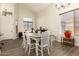 Open dining area with modern wood floors and lots of natural light from large windows at 14099 W Riviera Dr, Surprise, AZ 85379