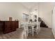 Bright dining room featuring modern wood floors, vaulted ceilings and elegant furnishings at 14099 W Riviera Dr, Surprise, AZ 85379