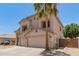 Two-story home with a neutral color palette, a two-car garage, and desert landscaping in the front yard at 14099 W Riviera Dr, Surprise, AZ 85379