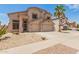 Two-story home with a neutral color palette, a two-car garage, and desert landscaping in the front yard at 14099 W Riviera Dr, Surprise, AZ 85379