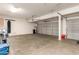 Two car garage with garage door openers, storage, and hot water heater at 14099 W Riviera Dr, Surprise, AZ 85379