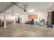 Spacious garage with overhead storage, workbench, and ample room for vehicles at 14099 W Riviera Dr, Surprise, AZ 85379