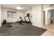 Home gym featuring rubber flooring and an array of workout equipment at 14099 W Riviera Dr, Surprise, AZ 85379