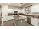 Stylish kitchen with granite countertops, stainless steel appliances and white cabinets at 14099 W Riviera Dr, Surprise, AZ 85379