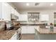 Modern kitchen with granite countertops, stainless steel appliances and white cabinetry at 14099 W Riviera Dr, Surprise, AZ 85379