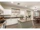 Spacious kitchen featuring a center island, stainless appliances, granite countertops and bright cabinets at 14099 W Riviera Dr, Surprise, AZ 85379