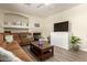 Comfortable living room features a cozy fireplace, large TV, neutral walls, and durable wood-look floors at 14099 W Riviera Dr, Surprise, AZ 85379