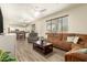 Comfortable living room with wood-look floors connecting to dining area and featuring lots of natural light at 14099 W Riviera Dr, Surprise, AZ 85379