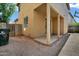 Rear exterior view with a covered patio, a waste container, and minimal landscaping at 1420 E Sonrisas St, Phoenix, AZ 85040