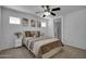 Comfortable bedroom with ceiling fan, wall art, and an ensuite bathroom at 1420 E Sonrisas St, Phoenix, AZ 85040
