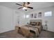 Well-lit bedroom with neutral tones, ceiling fan and bathroom access at 1420 E Sonrisas St, Phoenix, AZ 85040