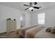 Neutral bedroom with ceiling fan, dresser, and a view of the ensuite bathroom at 1420 E Sonrisas St, Phoenix, AZ 85040