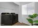 Well-lit laundry room with modern washer and dryer, and convenient storage at 1420 E Sonrisas St, Phoenix, AZ 85040