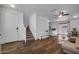 Open-concept first floor with wood-look floors, neutral walls, stairs, and a living room and dining area at 1420 E Sonrisas St, Phoenix, AZ 85040