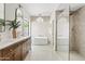 Stylish bathroom features dual vanities, a stand alone tub, and sleek lighting at 14401 N 60Th Pl, Scottsdale, AZ 85254