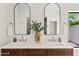Bathroom features a double sink vanity with stylish mirrors, gold fixtures, and modern decor at 14401 N 60Th Pl, Scottsdale, AZ 85254