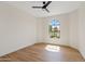 Sunlit bedroom boasts a large arched window and stylish light wood flooring at 14401 N 60Th Pl, Scottsdale, AZ 85254