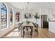 Charming dining area with bright windows, modern chandelier, and matching table setting at 14401 N 60Th Pl, Scottsdale, AZ 85254