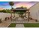 Backyard gazebo featuring a seating area, desert landscaping, and an entertainment space at 14401 N 60Th Pl, Scottsdale, AZ 85254