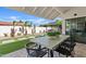 Covered patio includes chairs, a dining table, gazebo and artificial grass at 14401 N 60Th Pl, Scottsdale, AZ 85254