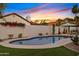 A serene backyard pool surrounded by desert landscaping and a privacy fence at 14401 N 60Th Pl, Scottsdale, AZ 85254