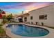 Beautiful backyard pool and outdoor space with a covered patio and blooming flowers at 14401 N 60Th Pl, Scottsdale, AZ 85254