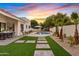 Charming backyard pool with pavers, desert landscaping, and a covered outdoor dining area at 14401 N 60Th Pl, Scottsdale, AZ 85254