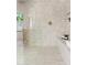 Luxurious tiled shower with a built in bench and glass enclosure at 14401 N 60Th Pl, Scottsdale, AZ 85254