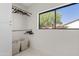 Spacious walk-in closet with shelves, hanging rods and window at 14401 N 60Th Pl, Scottsdale, AZ 85254