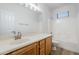 Neutral bathroom featuring a large mirror and tub with shower at 15853 N 74Th Ave, Peoria, AZ 85382