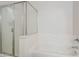 A white bathroom with a glass shower enclosure and soaking tub at 15853 N 74Th Ave, Peoria, AZ 85382