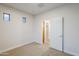 Neutral bedroom with a window, carpet, and an adjoining closet space at 15853 N 74Th Ave, Peoria, AZ 85382