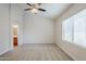 Neutral bedroom featuring a ceiling fan and an ensuite bathroom at 15853 N 74Th Ave, Peoria, AZ 85382