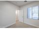 Bright bedroom featuring neutral carpeting, a window, and a white door at 15853 N 74Th Ave, Peoria, AZ 85382