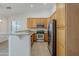 Kitchen with wood cabinets, stainless steel appliances, and wood-look floors at 15853 N 74Th Ave, Peoria, AZ 85382