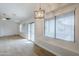 Light-filled living room with wood-look floors, and a sliding glass door to the back at 15853 N 74Th Ave, Peoria, AZ 85382