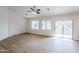 Bright living room featuring wood-look floors and a sliding glass door to the back at 15853 N 74Th Ave, Peoria, AZ 85382