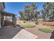 Backyard featuring a putting green, desert landscaping, and covered patio at 15955 N Cristine Ln, Surprise, AZ 85388