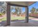 Backyard featuring a putting green, covered patio, and desert landscaping at 15955 N Cristine Ln, Surprise, AZ 85388