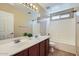 Bright bathroom with double sinks, large mirror, and shower-tub combo at 15955 N Cristine Ln, Surprise, AZ 85388