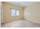 Bedroom featuring a large window for natural light and neutral walls with tile flooring at 15955 N Cristine Ln, Surprise, AZ 85388