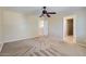 Carpeted bedroom with neutral walls, a ceiling fan, and multiple doorways to other rooms at 15955 N Cristine Ln, Surprise, AZ 85388
