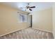 Neutral bedroom featuring a ceiling fan, carpet, and access to a closet at 15955 N Cristine Ln, Surprise, AZ 85388