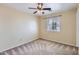 Neutral bedroom features carpet, ceiling fan, and window for natural light at 15955 N Cristine Ln, Surprise, AZ 85388