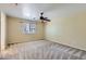 Bedroom features a ceiling fan, window and light colored walls with carpet flooring at 15955 N Cristine Ln, Surprise, AZ 85388